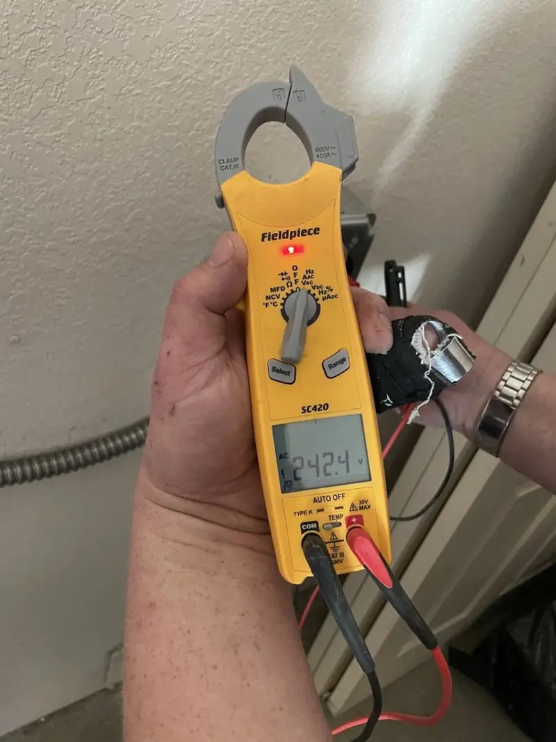 Voltage testing with clamp meter during Generator Installation in Bangor Base